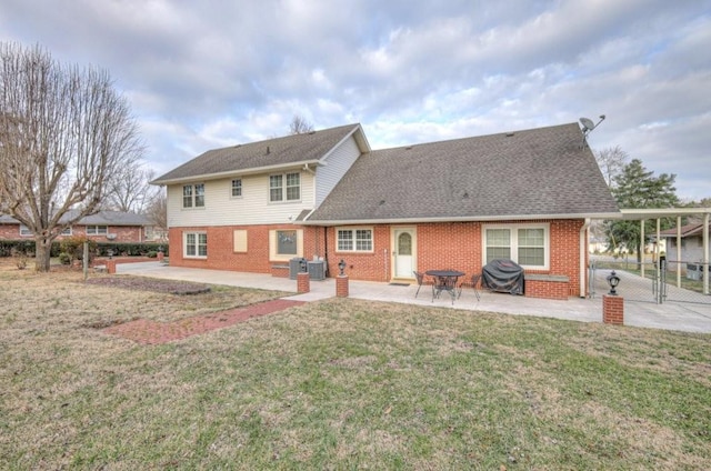 back of house featuring cooling unit, a patio area, and a lawn