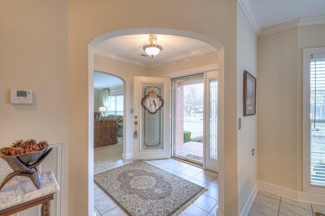 tiled foyer entrance featuring ornamental molding