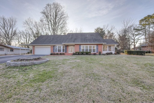 ranch-style home with a garage and a front lawn