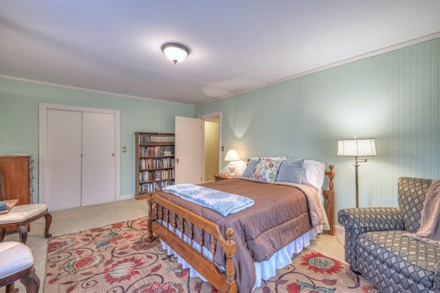 carpeted bedroom featuring crown molding and a closet