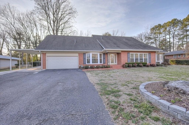 single story home with a carport, a garage, and a front lawn