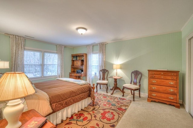 bedroom with multiple windows, ornamental molding, and light colored carpet