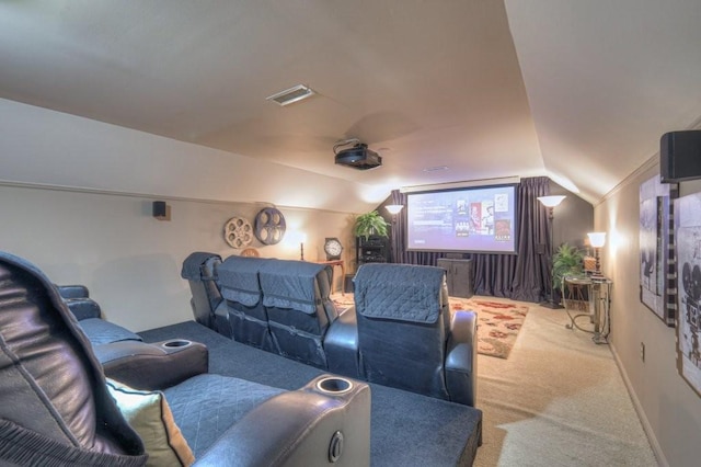 home theater featuring lofted ceiling and light colored carpet