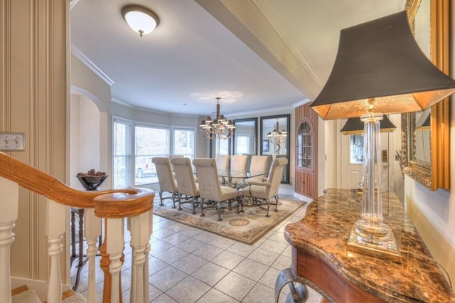 dining area featuring crown molding, light tile patterned floors, and a notable chandelier