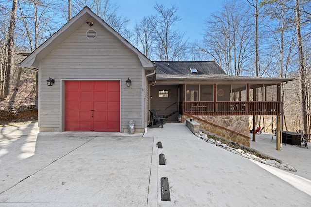 view of front of house featuring a garage and a sunroom