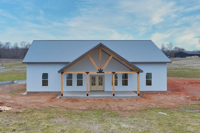 back of property featuring a patio, a yard, and french doors