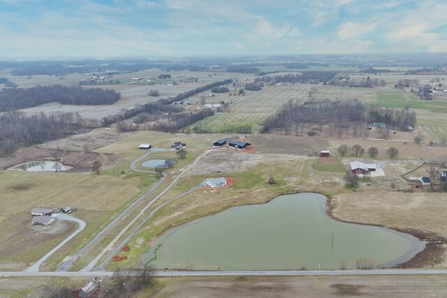 birds eye view of property featuring a water view and a rural view