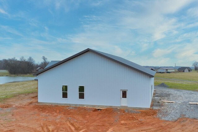 view of side of home featuring a water view