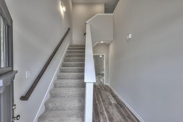 stairs with hardwood / wood-style floors