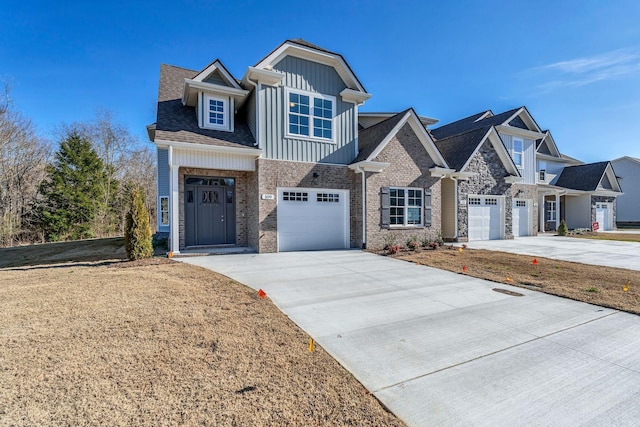 view of front of home with board and batten siding, brick siding, and driveway