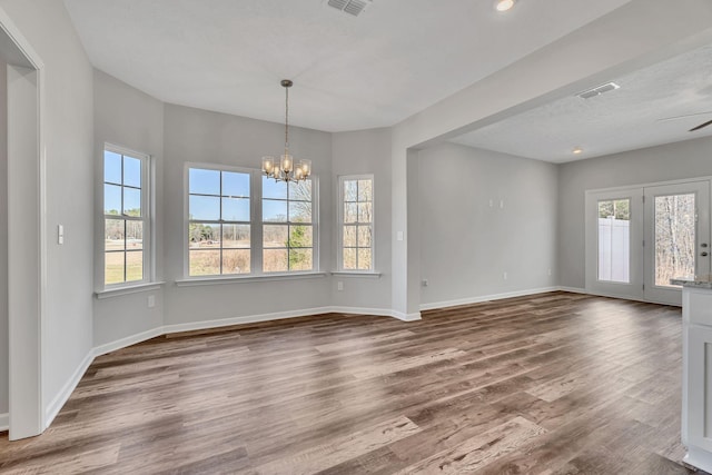 interior space featuring a notable chandelier, recessed lighting, visible vents, wood finished floors, and baseboards