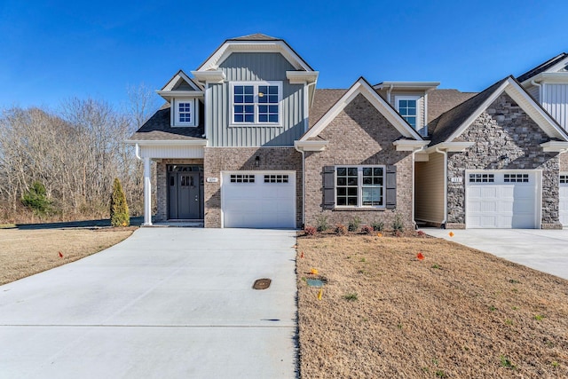 craftsman inspired home with driveway, board and batten siding, and a front yard