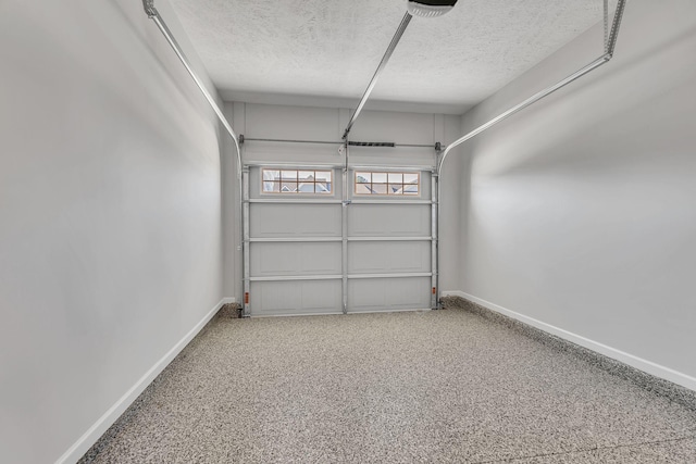 garage featuring baseboards and a garage door opener