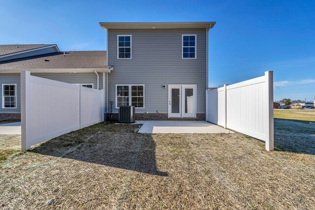 back of house featuring a yard, fence, central AC unit, and a patio