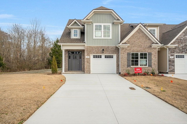 craftsman-style house with an attached garage, a shingled roof, brick siding, driveway, and board and batten siding