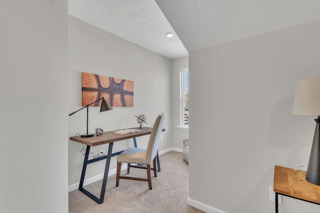 home office with light carpet, a textured ceiling, and baseboards