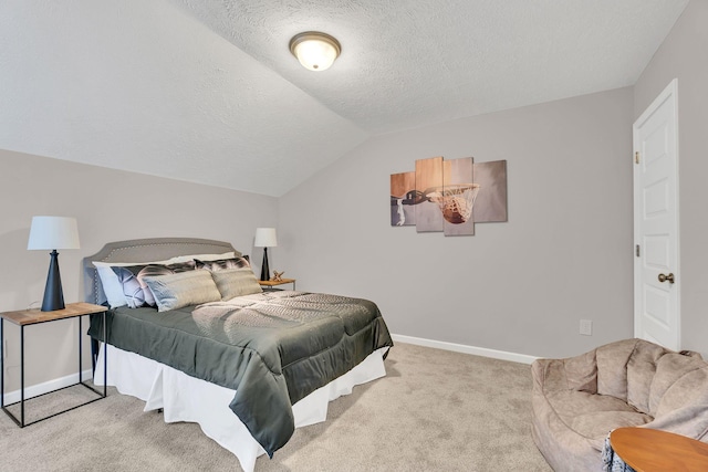 bedroom with light colored carpet, vaulted ceiling, a textured ceiling, and baseboards