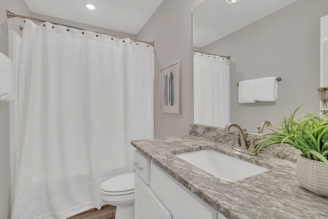 full bathroom with toilet, shower / tub combo with curtain, wood finished floors, and vanity