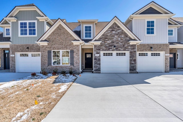 craftsman-style house featuring board and batten siding, stone siding, an attached garage, and concrete driveway