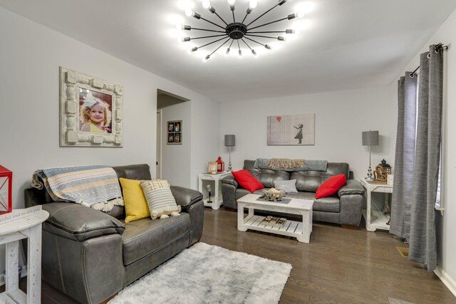 living room featuring dark hardwood / wood-style flooring and a notable chandelier