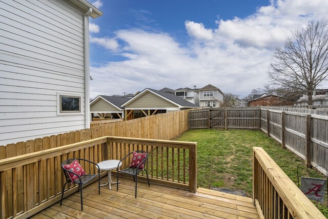 wooden deck featuring a lawn