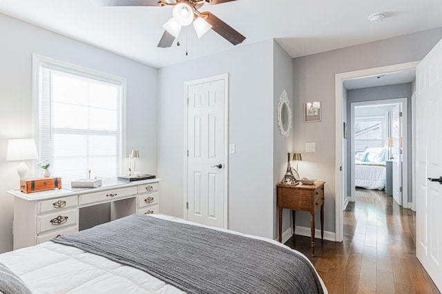 bedroom with dark hardwood / wood-style floors and ceiling fan