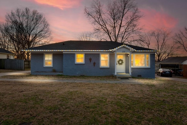 ranch-style house with a lawn and a carport