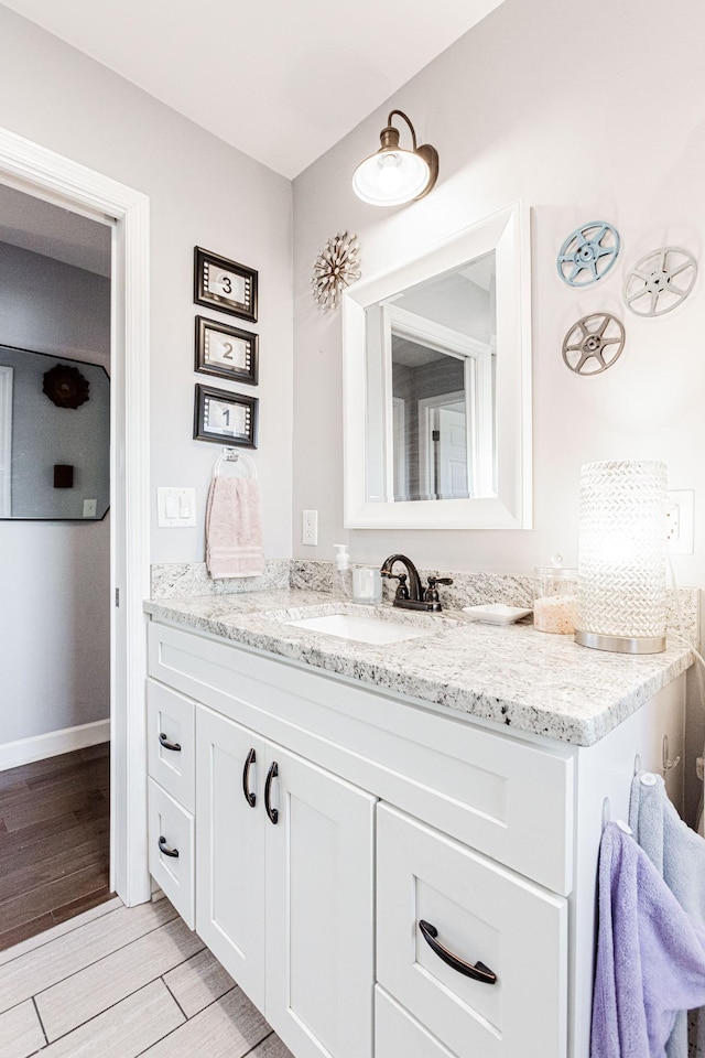 bathroom featuring vanity and hardwood / wood-style floors