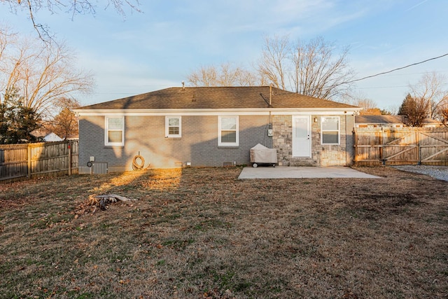 back of house with a patio area and a lawn