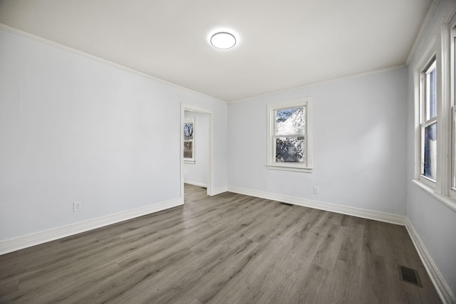 unfurnished room featuring ornamental molding and hardwood / wood-style floors