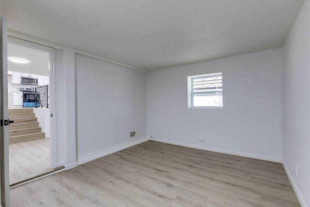 spare room with light hardwood / wood-style floors