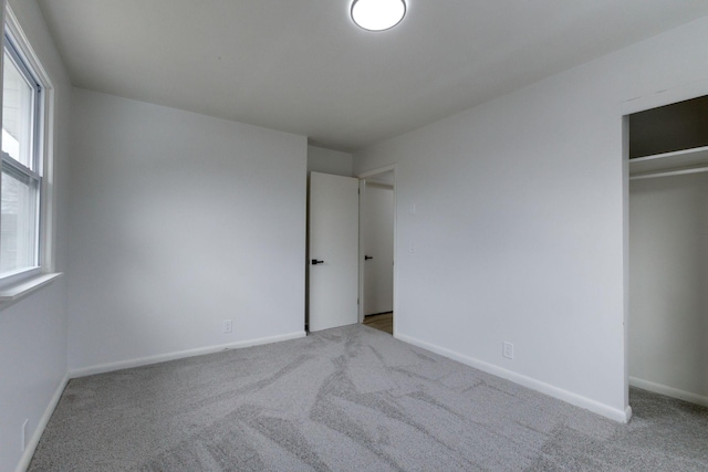 unfurnished bedroom featuring light carpet