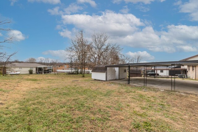 view of yard with a carport and a storage unit