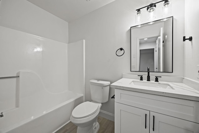 full bathroom with wood-type flooring, shower / bathing tub combination, vanity, and toilet