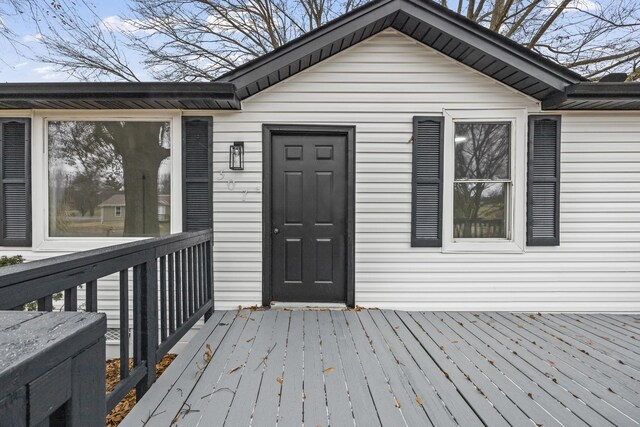 view of exterior entry with a deck