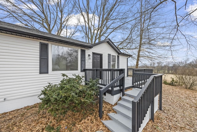 view of exterior entry featuring a deck