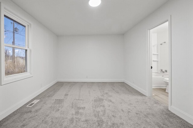 empty room featuring light carpet