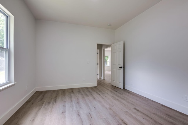 empty room featuring light hardwood / wood-style flooring and plenty of natural light