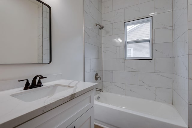 bathroom featuring vanity and tiled shower / bath