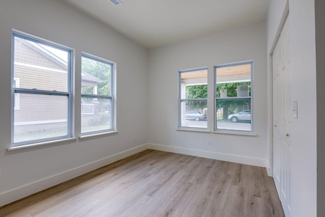 spare room with light hardwood / wood-style floors