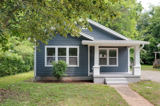 bungalow-style house with a porch and a front lawn