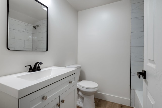 bathroom featuring vanity, toilet, wood-type flooring, and a shower