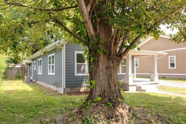 view of property exterior featuring cooling unit and a lawn