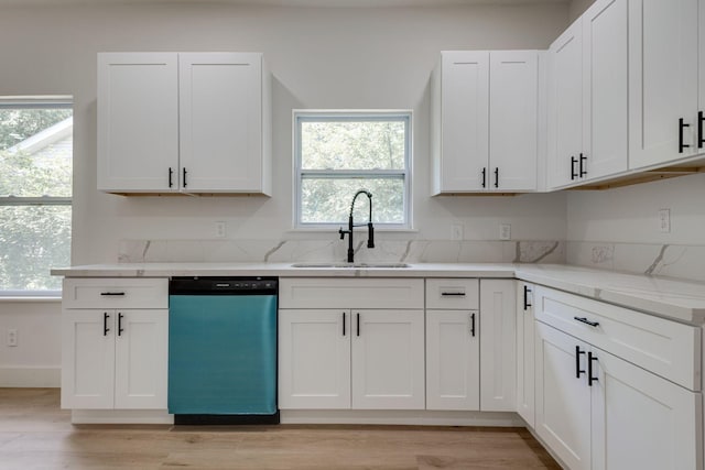 kitchen featuring light hardwood / wood-style floors, dishwasher, sink, and white cabinets