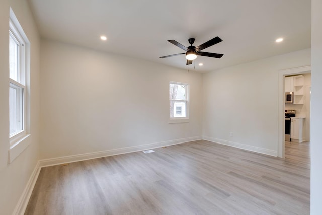 unfurnished room featuring ceiling fan and light hardwood / wood-style flooring