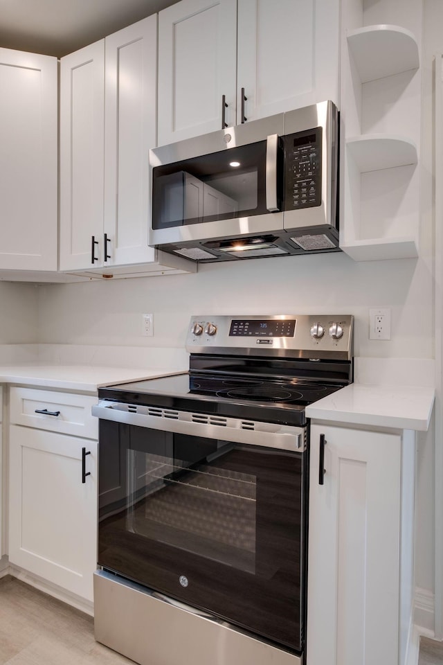 kitchen featuring stainless steel appliances and white cabinets