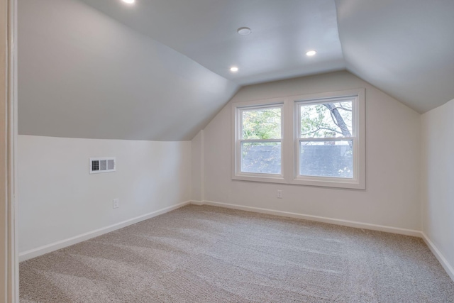 additional living space with lofted ceiling and carpet