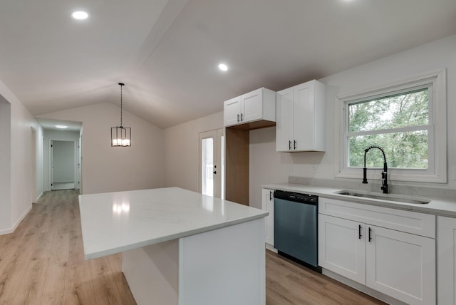 kitchen with sink, decorative light fixtures, stainless steel dishwasher, a kitchen island, and white cabinets