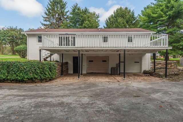 front of property featuring a garage and a wooden deck