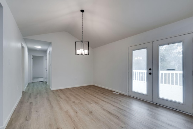 unfurnished dining area with vaulted ceiling, light hardwood / wood-style floors, and plenty of natural light